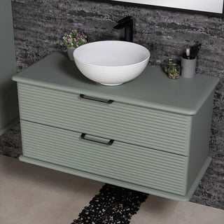 Libra 100 cm salaviju spalvos spintele su balta apvalia kriaukle ir juodu maisytuvu.